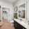 Large well lit bathroom with white accents 