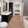 Large well lit bathroom with white accents 