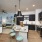 Spacious and well lit kitchen with wood flooring and stainless steel appliances
