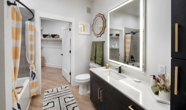 Large well lit bathroom with a large walk-in shower 